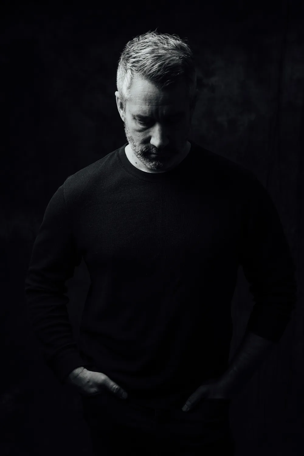 Black and white portrait of Matt MacIsaac looking down